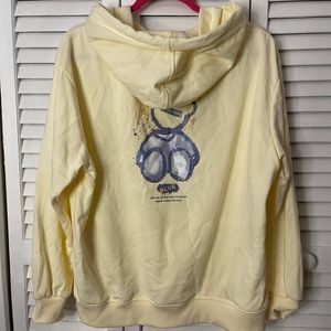 Graphic hoodie with bear pattern.